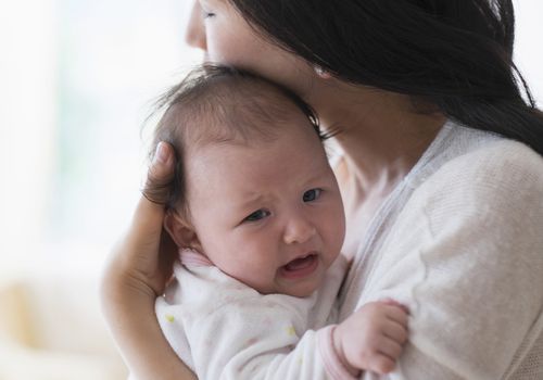 asian-mother-comforting-crying-baby