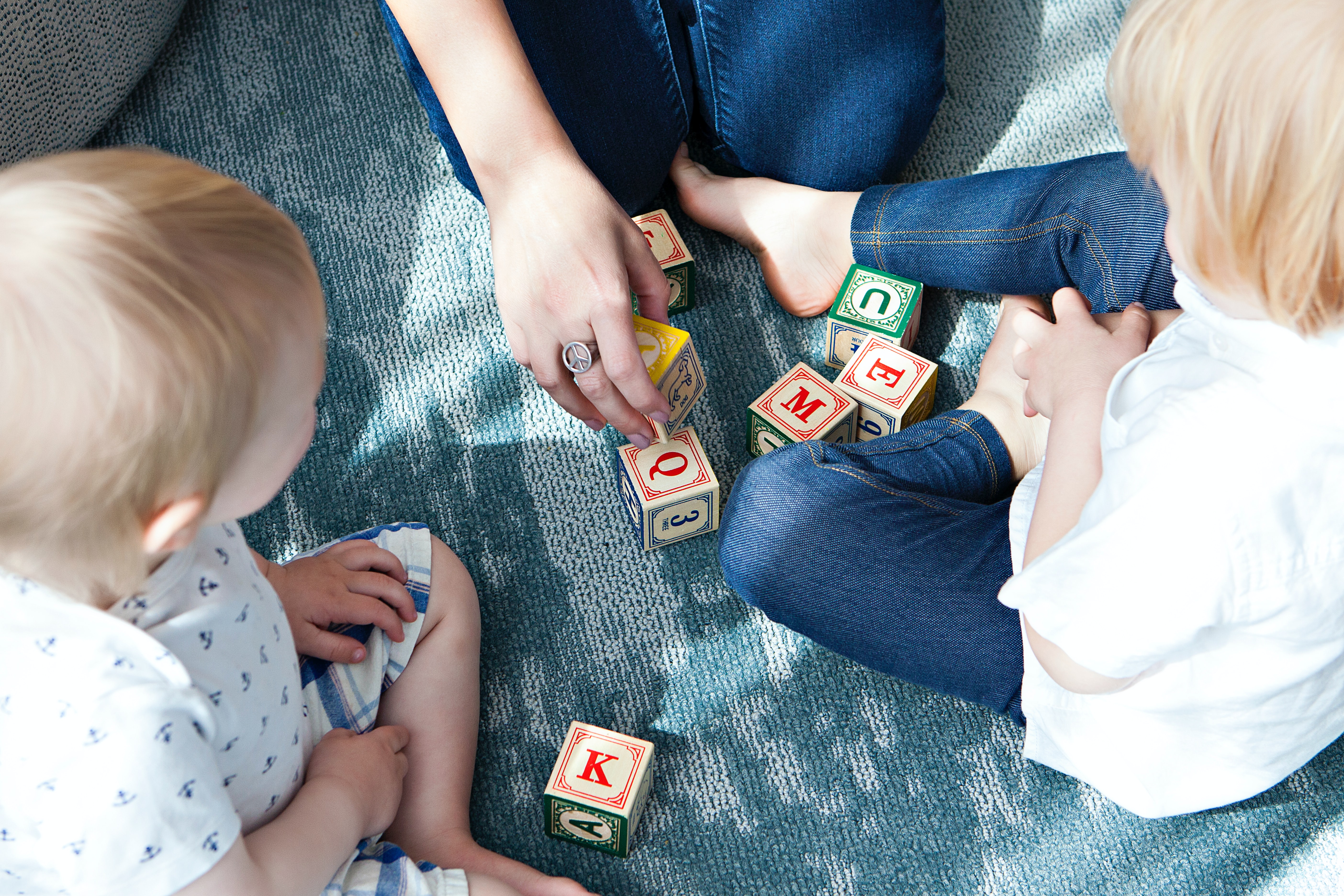 toddlers playing with letter cubes