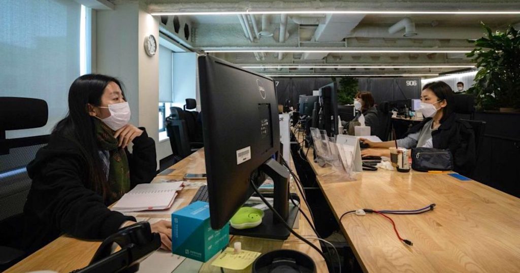 people wearing masks in an office