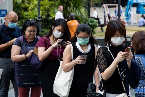 a queue of people using their phones