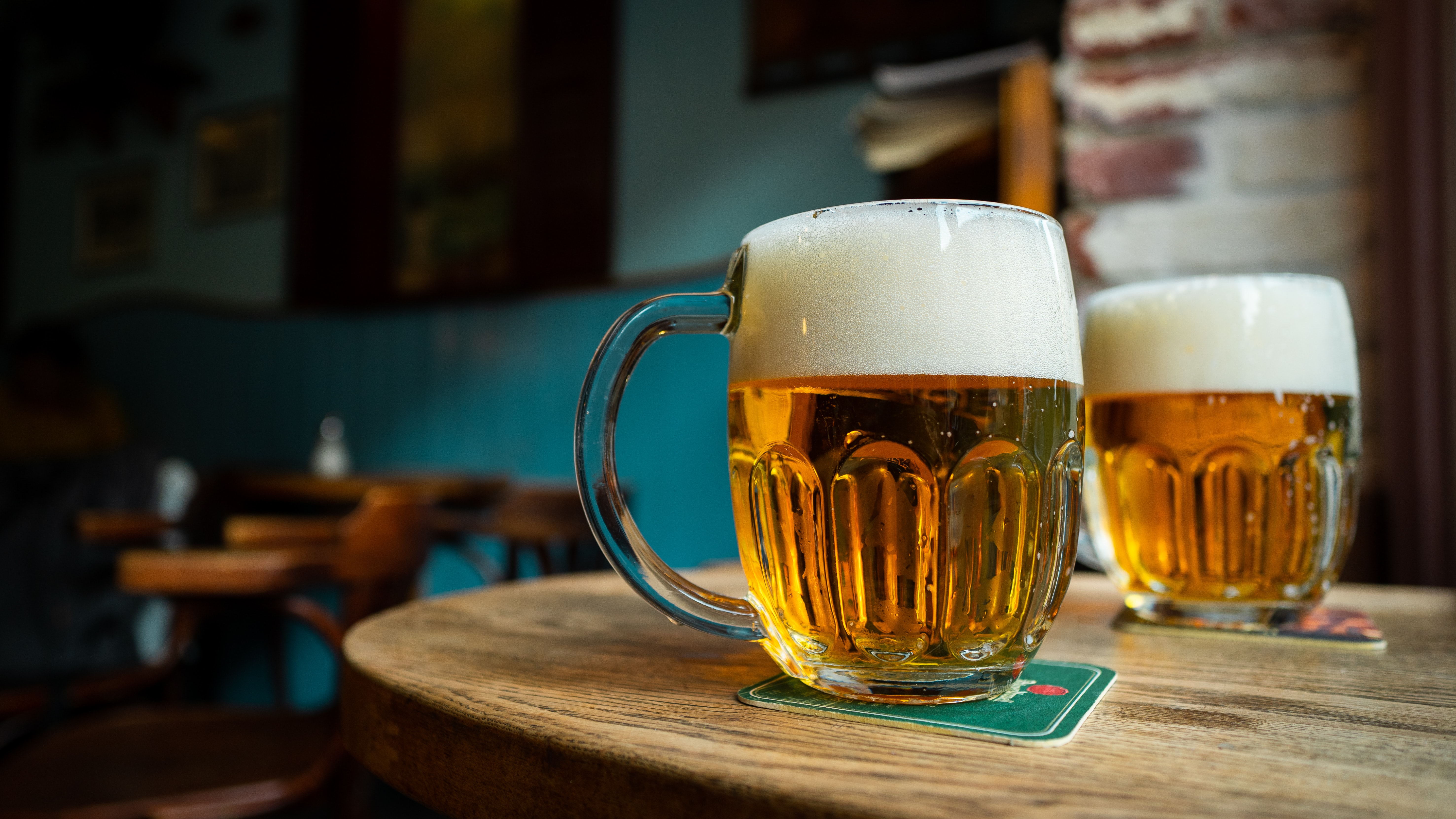 two mugs of beer on a table