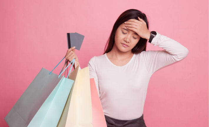 an asian lady holding on to shopping bags