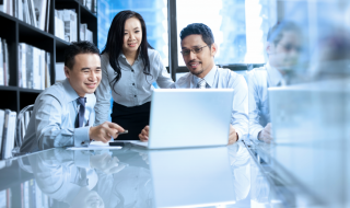 colleagues looking at a laptop