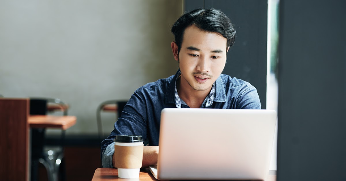 a man looking at his laptop