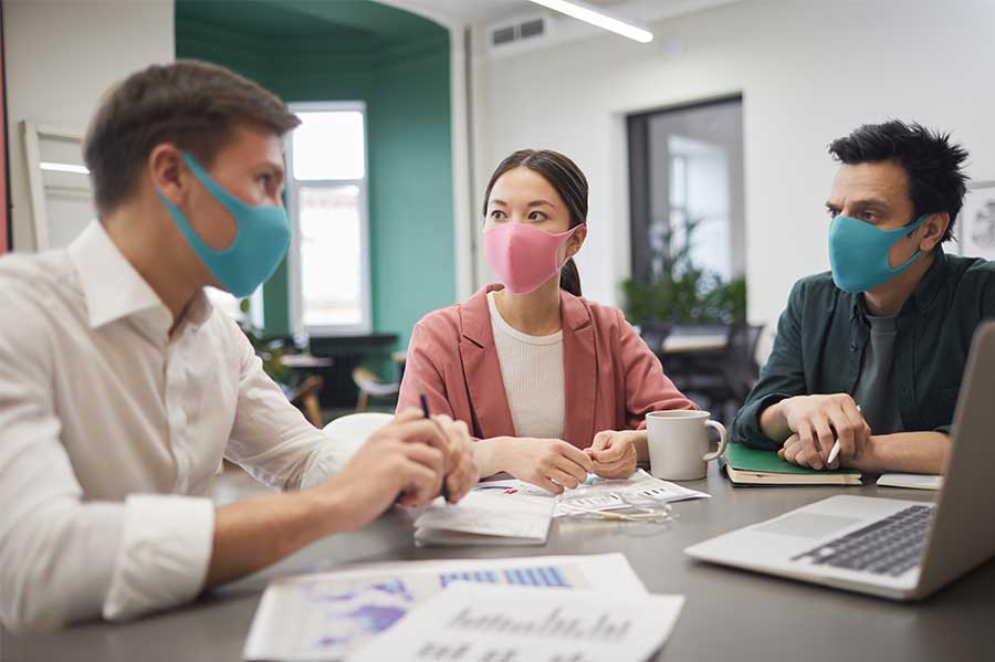 colleagues in masks conversing