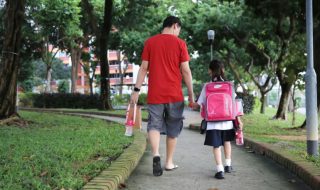 a father and daughter on the way to school