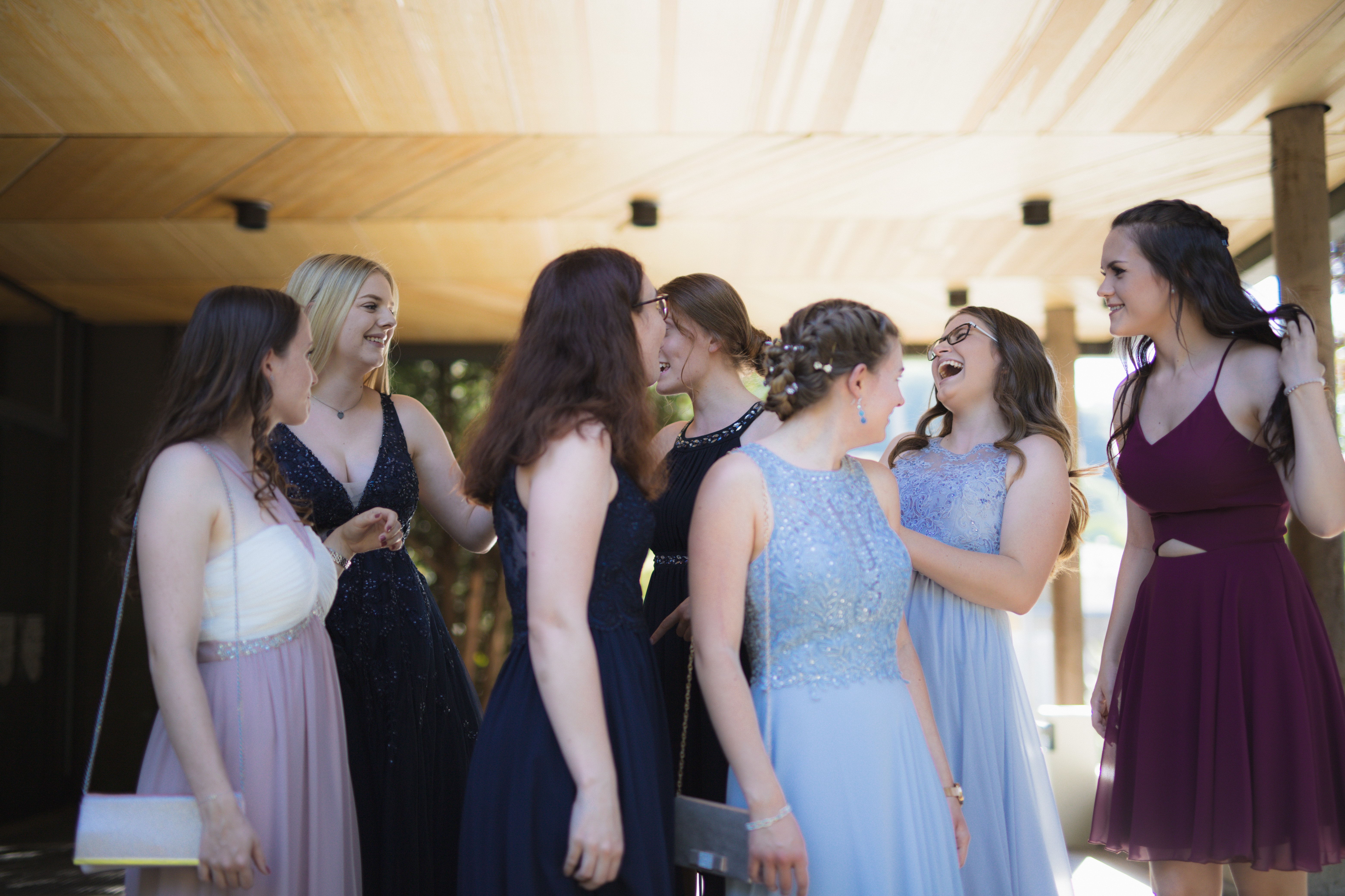 women in dresses gathering before an event