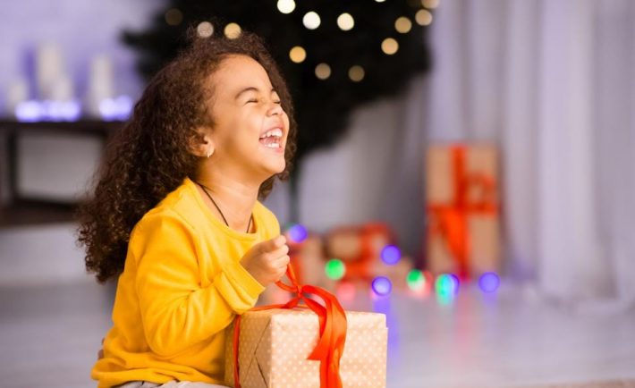 kid delighted with a Christmas gift