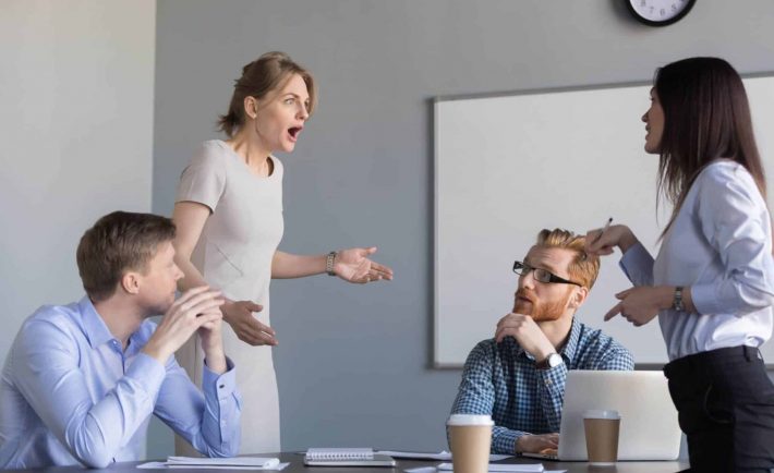 female colleagues disagreeing in a meeting