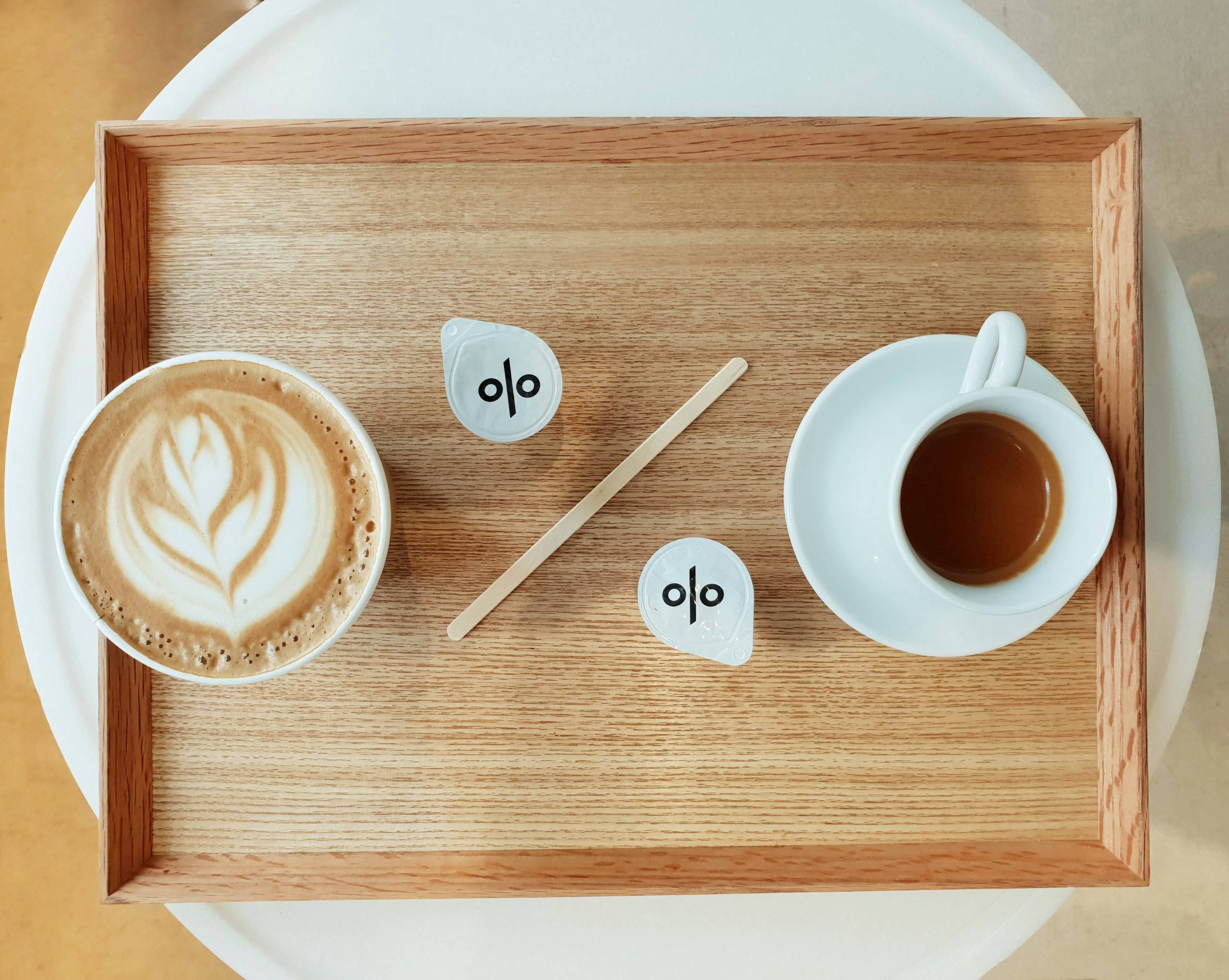 two cups of coffee on a tray