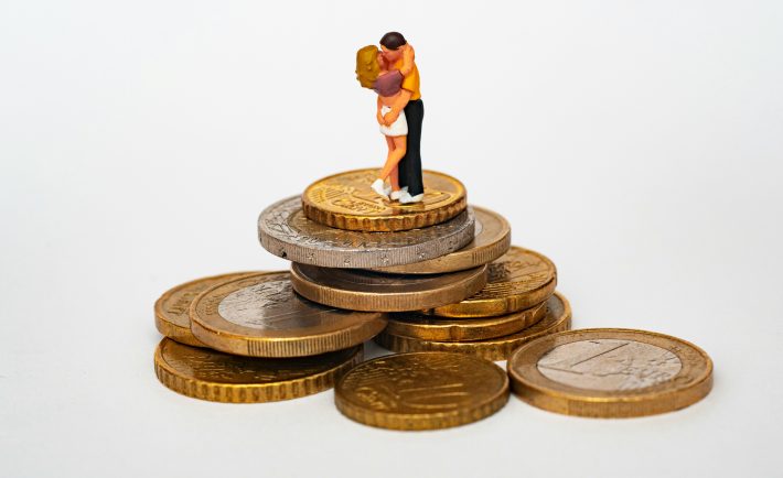 couple figurines on top of coins