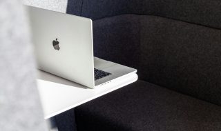 a MacBook on a white desk