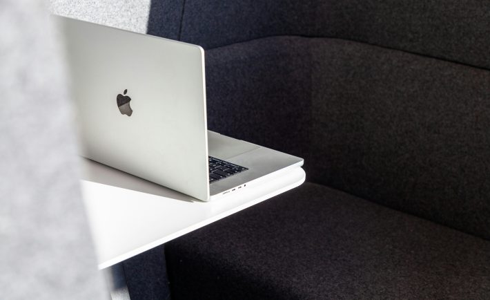 a MacBook on a white desk