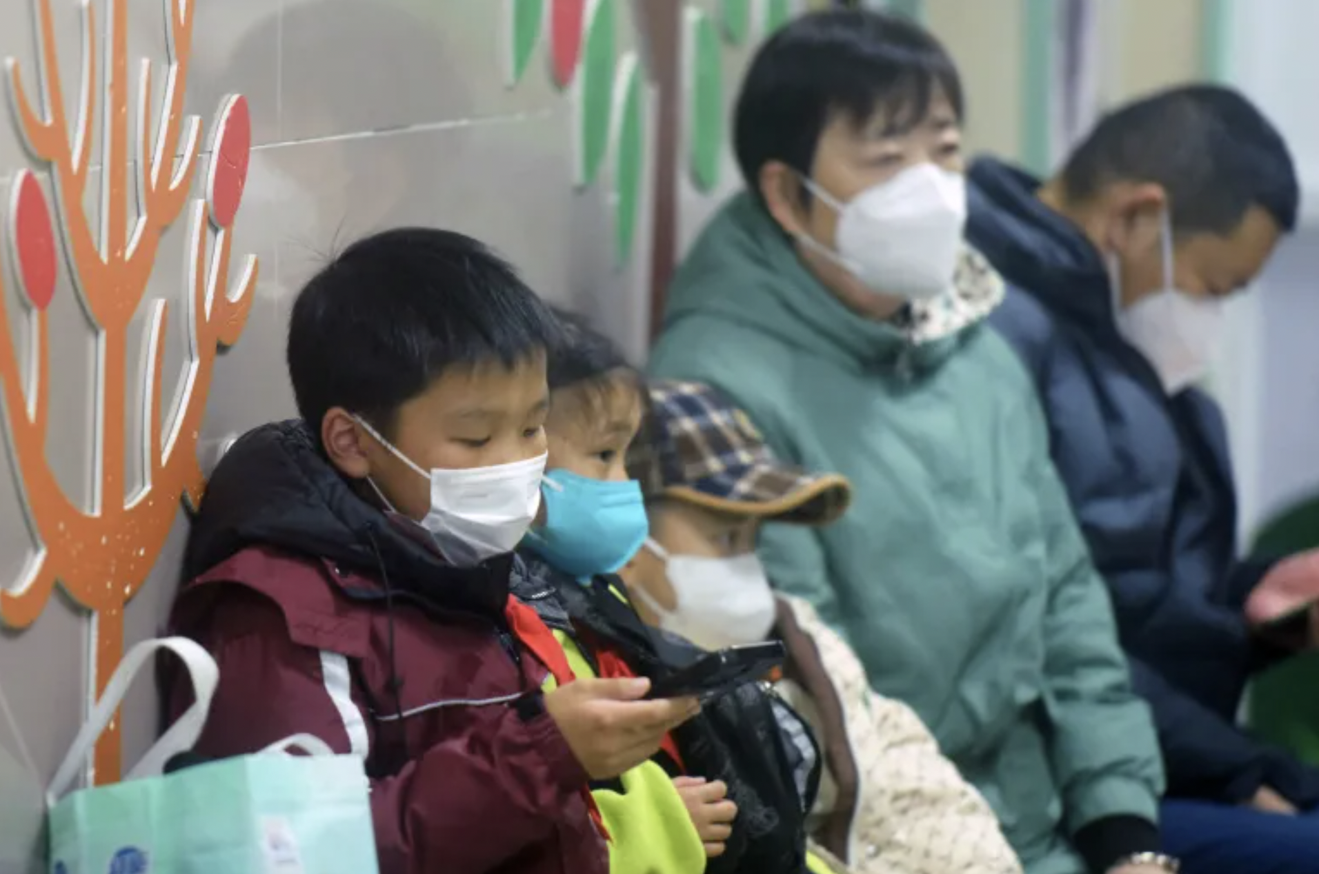 Masked children waiting to see the doctor