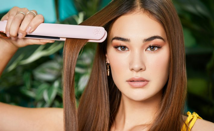 woman straightening her hair