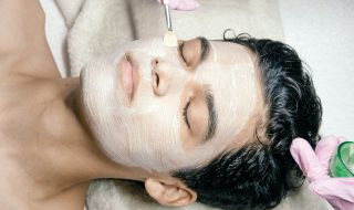 a man getting a facial mask