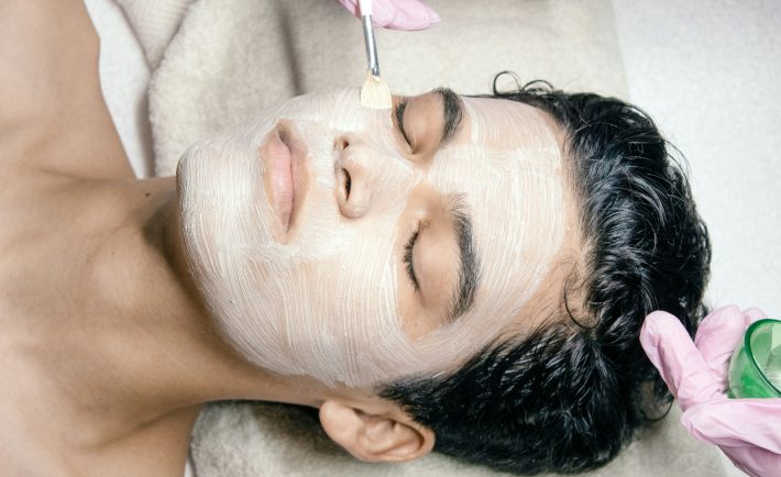 a man getting a facial mask